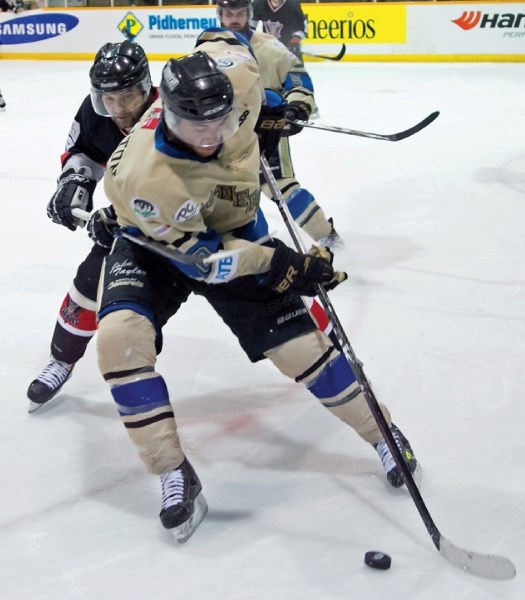 Bentley Generals centre and Blackie native Jeremy Colliton shields the puck from a Clarenville Caribous during the Allan Cup gold medal game April 20 at the Red Deer Arena.