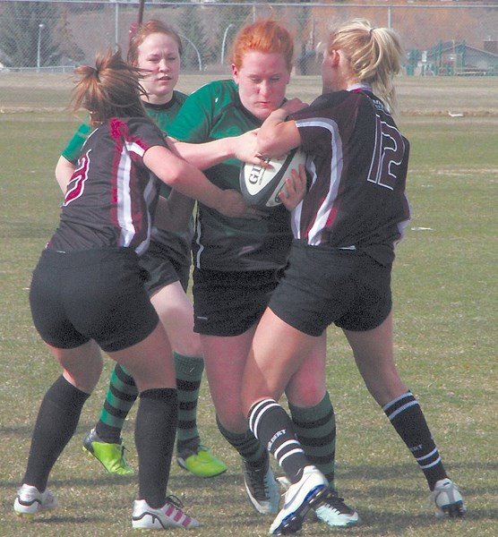Holy Trinity Academy Knight Macaih Schneider bulldozes her way in for the first try against the Foothills Falcons on Thursday at Falcon Field. The Falcons won the game 31-0.