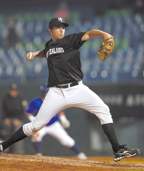 Jamie Wilson hurls a pitch against the Philippines at the World Baseball Classic in late 2012. Wilson is the first New Zealand player to play for the Okotoks Dawgs.
