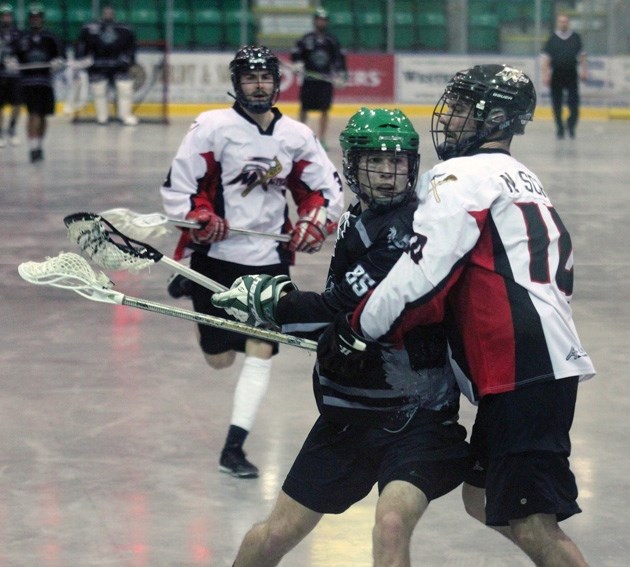 Okotoks Sr. B Raider Sean Miller fights to get by St. Albert Miner Nate Schmidt during the Raiders&#8217; 8-7 victory on Sunday at the Pason Centennial Arena.