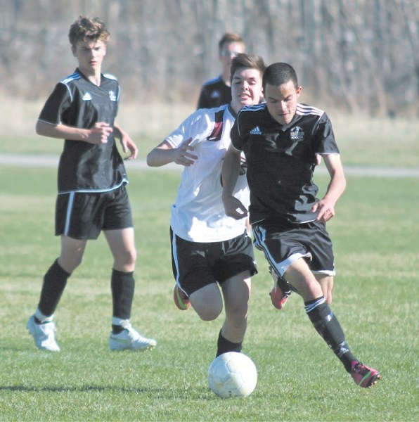 Holy Trinity Academy Knight striker Sergio Espino (right) gets behind a Foothills Falcon defender during FAC play last week. Espino scored two goals in the Knights&#8217;