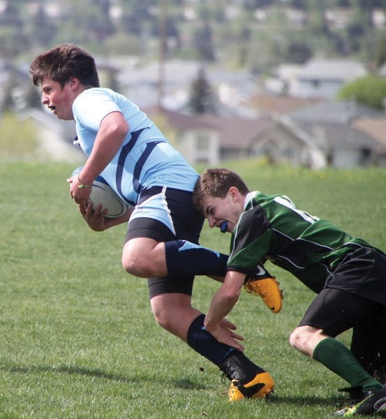 Strathcona-Tweedsmuir Spartan Andy Rusnac breaks a tackle in their 38-12 victory over the Springbank Phoenix in the South Central Zone Tier II semifinal Monday at the Calgary 