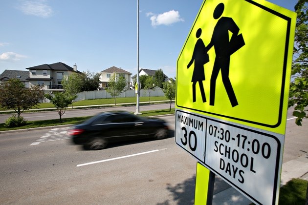 A vehicle passes through a school zone on Milligan Drive on June 30. Okotoks council is waiting to see if Calgary extends school and playground zones to 9 p.m. and will