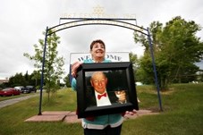 Maureen Parsons holds a photo of her father Bob Lochhead in front of the former Centennial Campground in Black Diamond, which was renamed Bob Lochhead Memorial Park in his