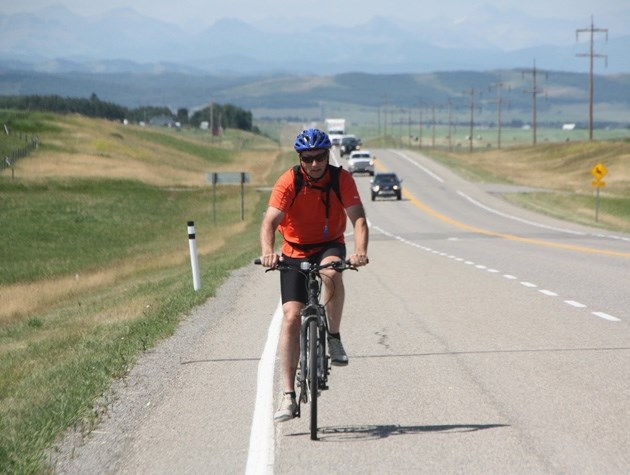 Cancer survivor Walt Stevenson, of Turner Valley, powers up a hill near Okotoks in preparation for the Enbridge Ride to Conquer Cancer ride this weekend.