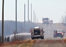 Fire crews work to douse a brush fire started by fireworks along Highway 22 south of Longview in spring of 2014. Changes to Turner Valley&#8217; s fire protection bylaw hopes 