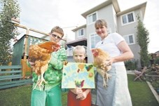 Jenni Bailey and her sons hold the chickens that used to live in their backyard. The family had to get rid of their hens last year.