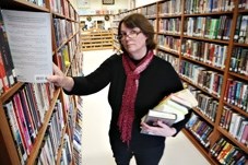 Sheep River Library manager Jan Burney shelves books at the Turner Valley library. The facility will see an increase of a part-time position to full-time in January to meet