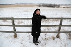 Deanna Balfour looks over the site of the proposed 2,600 home Ribstone Ranch east of Heritage Heights School. Balfour is part of a group of area residents who have concerns
