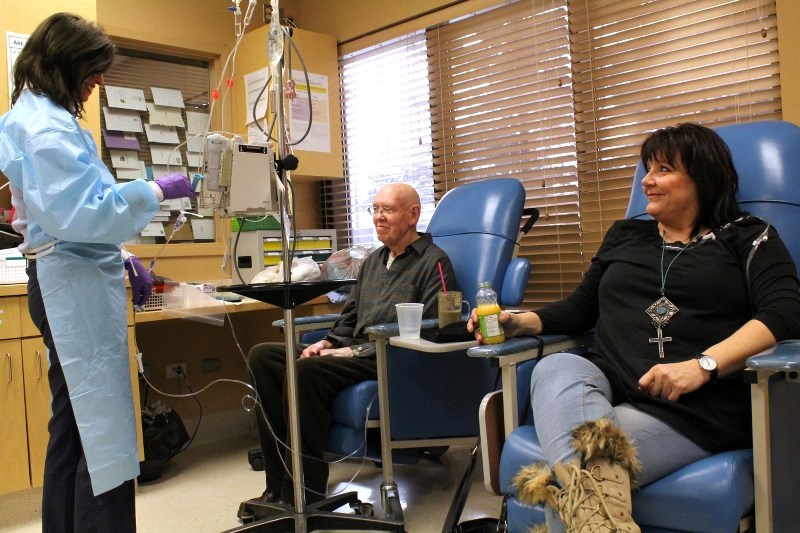 Nurse Kate Olson administers cancer treatment to patients Barry Knaggs and Liza Nichols at the High River Community Cancer Centre. The centre will undergo a $2 million
