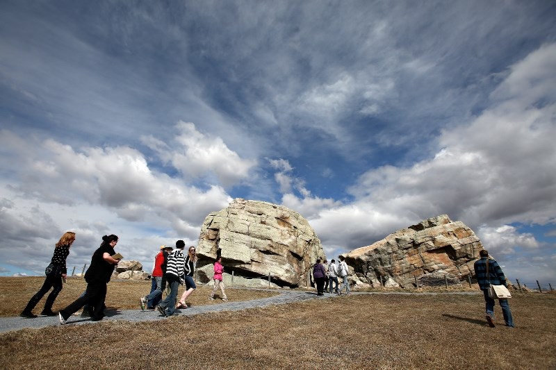 Visitors take in the Okotoks Erratic. The Big Rock is being included in a new 3D digital archive of the world&#8217;s top 500 most significant cultural sites.