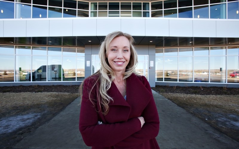 Foothills School Division chairwoman Christine Pretty stands in front of the Legacy Field House in Aldersyde where a proposed high school may be built. The Town of Okotoks is 