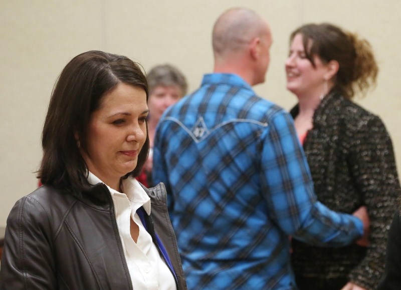 Outgoing Highwood MLA Danielle Smith looks on as Okotoks town coun. Carrie Fischer celebrates with her husband Chris after winning the nomination to become the PC