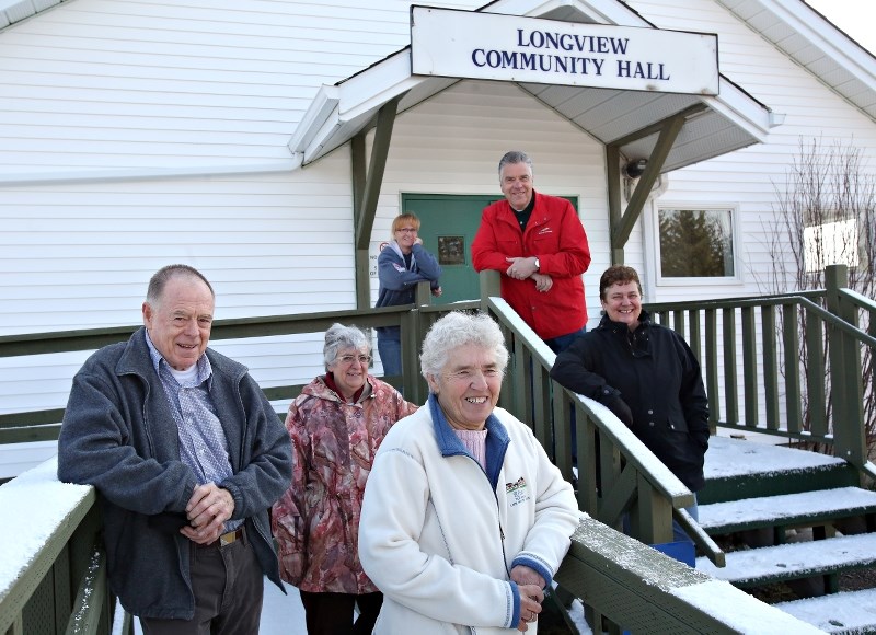 Doreen and Jack Chisholm, Ann Davis, Andrea Kidd, Ivor McCorquindale and Rose Klassen stand in front of the Longview Community Hall, which will be the hub for many