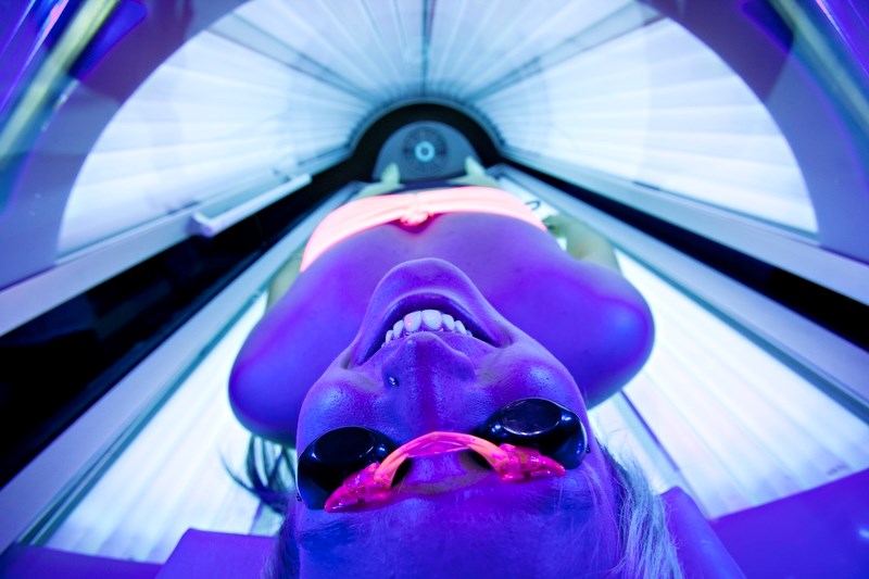 Melissa Rogers soaks up the rays in a tanning bed at iTan 360. The Alberta government has introduced new legislation that will ban anyone under 18 from using the beds.