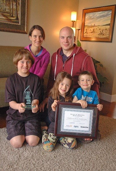 Shari and Andrew Gustafson, top row, sit with their children, bottom row, left to right, Josiah, Eva and Seth. The couple was honoured for their volunteer efforts in the