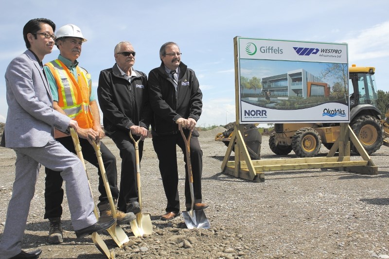 From left, Brian Tezuka with Norr Architects Engineers Planners, Pat Blais with Giffels West Pro, Operations director Dave Robertson, and Mayor Bill Robertson dig in their