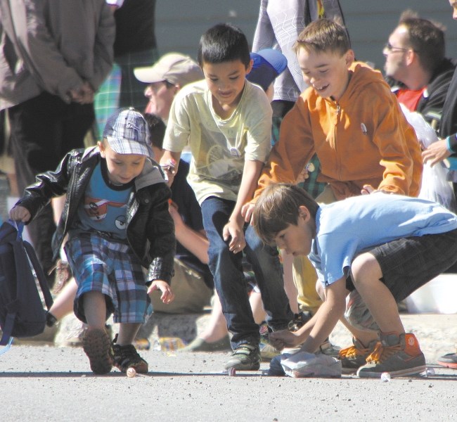 Youngsters scramble for candy during the Diamond Valley Parade last year. This year&#8217; s parade and Turner Valley&#8217; s Discovery Days takes place on June 6.