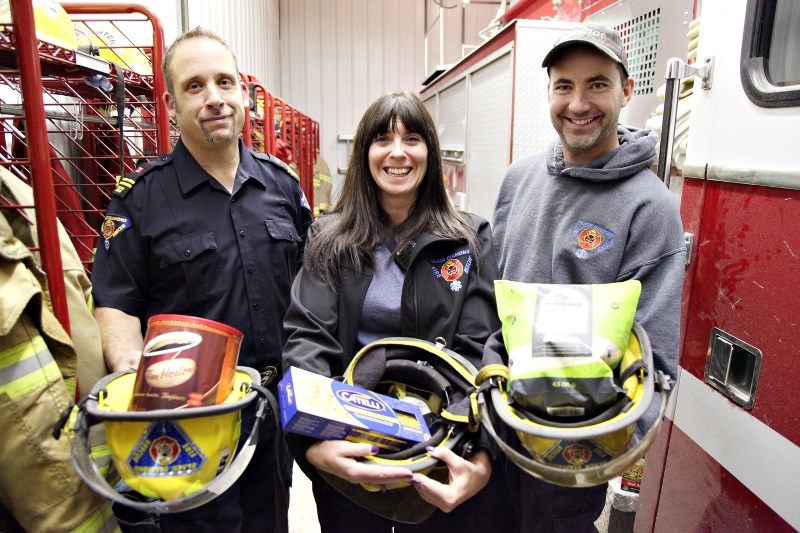 From left, Black Diamond Fire Rescue&#8217; s Mike Kline, Jamie Kline and Shawn Mackenzie collected several food items during the firefighters food drive last year. Oilfields 