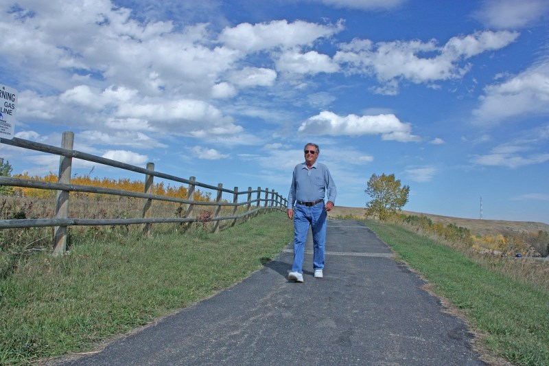 Ray Anholt takes a stroll along the Friendship Trail on Sept. 25. Walking trails was identified as one of the needs area residents suggested in Turner Valley&#8217; s Paths,