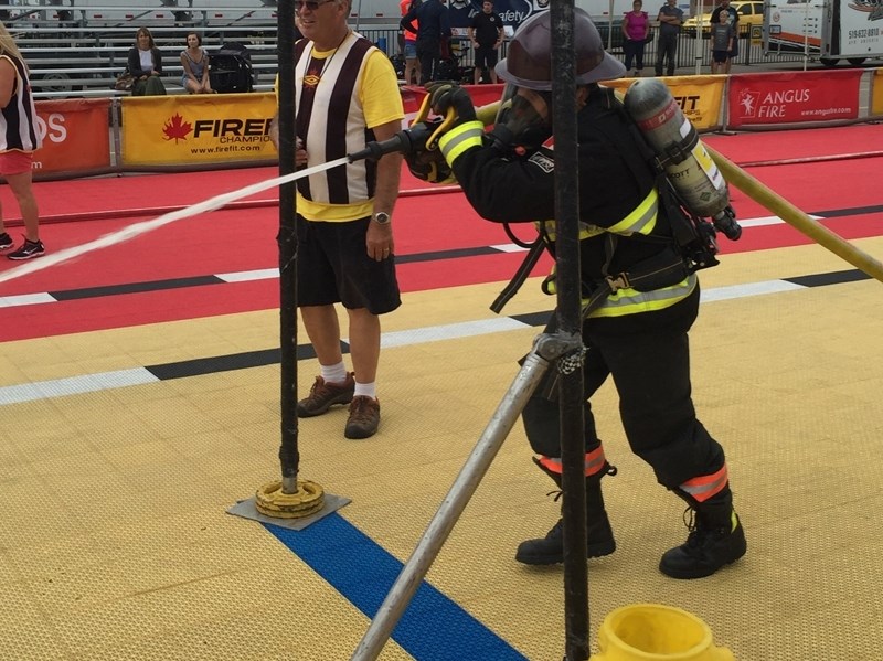 MD of Foothills firefighter Russ Friesen aims a hose at the Canadian National Firefighters Championships in Kitchener, Ontario in September.