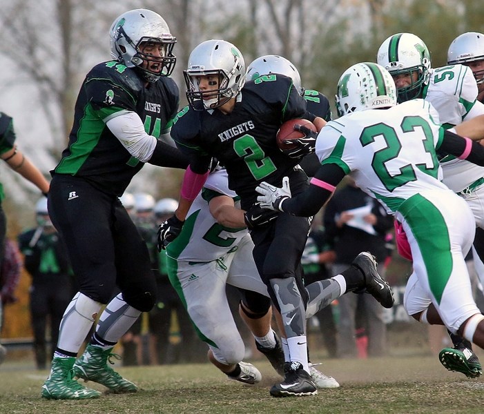 Luke Welton rushes the ball forward for the Holy Trinity Academy Knights in their 16-10 victory over the Medicine Hat Mohawks on Oct. 2 in Okotoks.