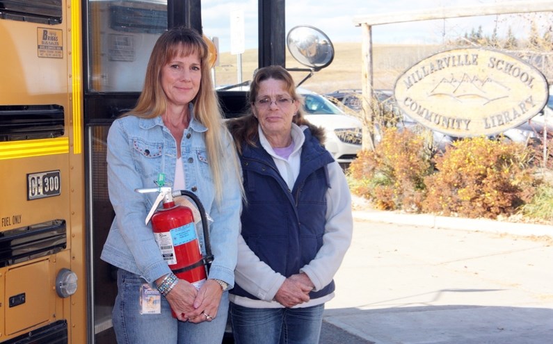 Millarville School bus driver Lisa Willis, left, helped put out a fire she saw while dropping off a student on Oct. 16. Wendy Arkes, right, pitched in by completing