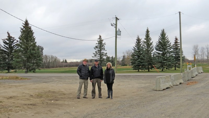 Area residents, from left, Murray Knowler, Ron Thomson and Brenda Hoff stand in an area motorists have been accessing the Turner Valley Golf Club since the closure of