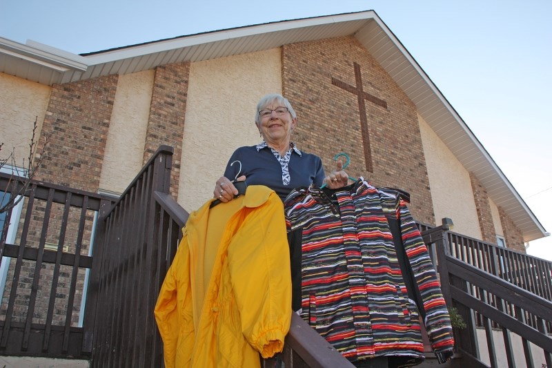 Jacket Racket volunteer Ida Wegelin holds some of the items donated to the cause last week. Donations continue to be accepted at the United Church until Dec. 16.