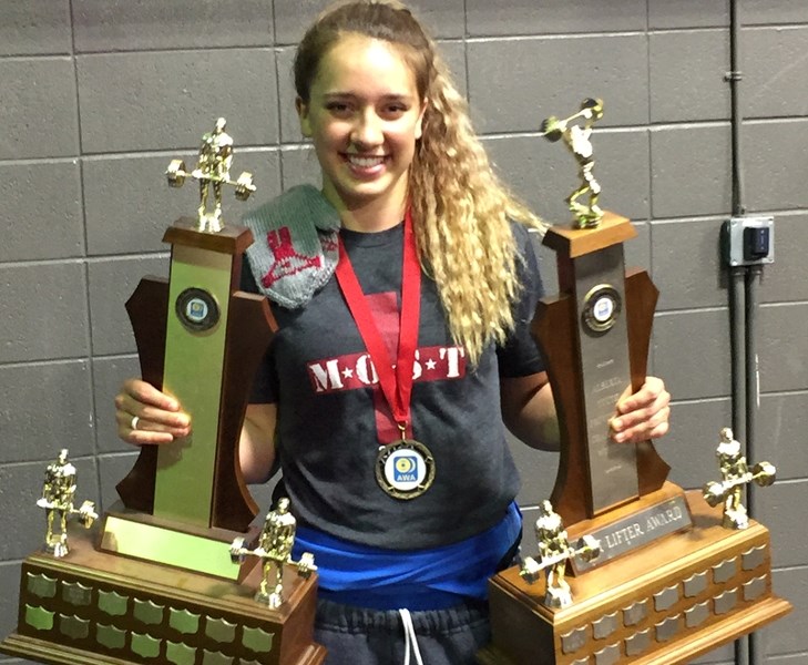Foothills Composite student Liv Price poses with her awards at the Alberta Youth and Junior Powerlifting Provincials in Edmonton on Nov. 7. Price set five provincial records