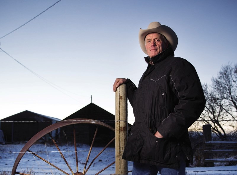 Foothills rancher Ralph Nelson stands on his ranch west of High River. He said the provincial government is moving too quickly on a plan to move farm workers under labour