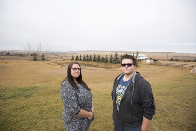 Tammy Holunga and her on Alex stand outside of their home on an acreage southwest of Okotoks on Saturday, Nov. 14, 2015. The Holungas have been plagued with poor internet