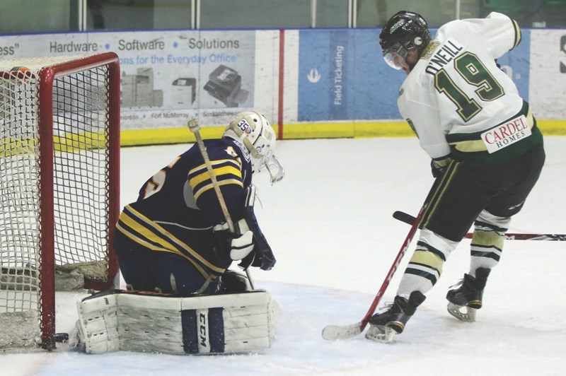 Okotoks Oilers centre Colin O&#8217;Neill slips the puck past Calgary Mustangs goaltender Ryan Ternes at Pason Centennial Arena on Nov. 21. The goal sparked a 5-0 run in