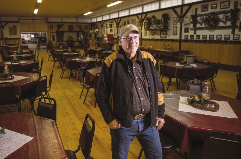 Gus Leduc, owner of Lynnwood Ranch, stands in the venue&#8217; s main hall with tables ready for holiday partiers.