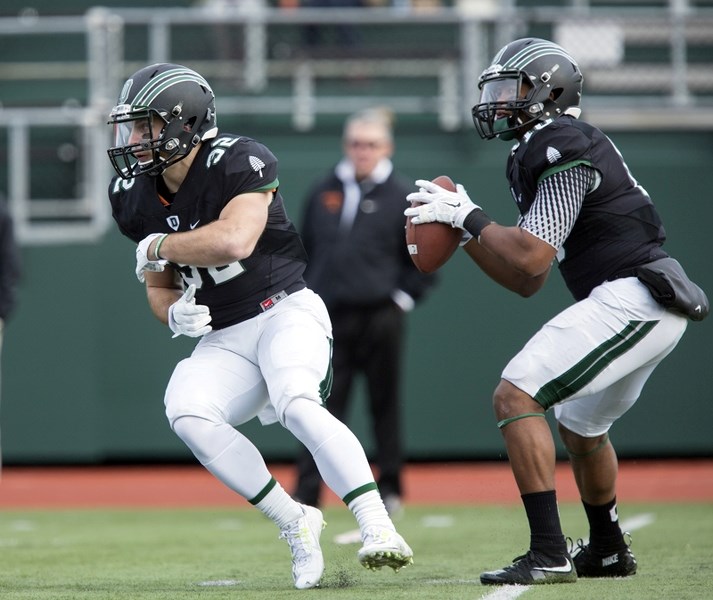 Ryder Stone, left, here on a hand-off from quarterback Dalyn Williams, was the leading rusher for the 2015 Ivy League champion Dartmouth Big Green. He was a guest speaker at