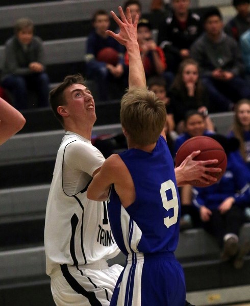 Holy Trinity Academy KnightSeth Moser goes up for a shot against the Highwood Mustangs on Dec. 9 in Okotoks.