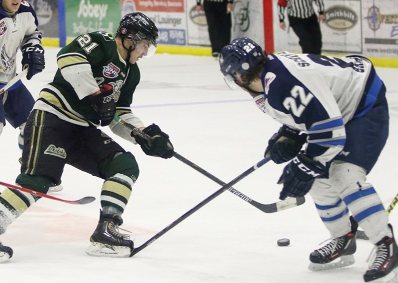 Jordie Lawson stick handles past Canmore Eagles defenceman Brett Schimmel during the Okotoks&#8217; Oilers 3-2 win on Jan. 2 at Pason Centennial Arena.