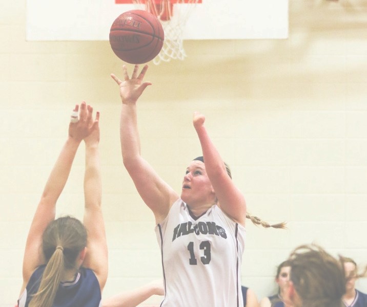 Foothills forward Annaliese Curtis shoots the ball over the Strathmore Spartans&#8217; defence at the Falcons&#8217; home opener at Foothills Composite High School on Jan. 6.