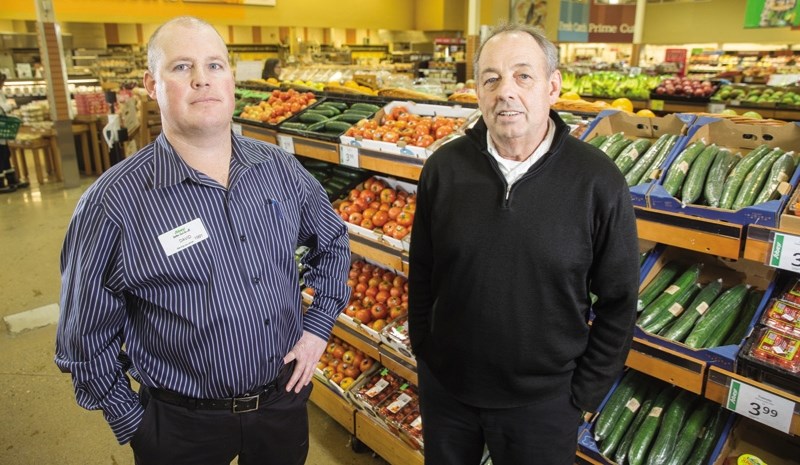 Okotoks Sobeys owner David Gilbert and his uncle Greg, the store&#8217; s produce manager, on Jan. 13. A low Canadian dollar may begin to impact prices of imported goods,