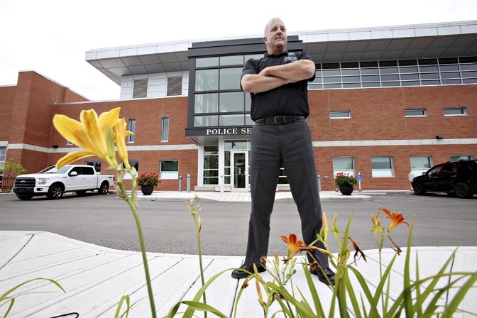 Scott Roberts stands outside the Okotoks RCMP detachment in 2015. The Alberta Association of Police Governance is calling for equitable police funding province-wide.