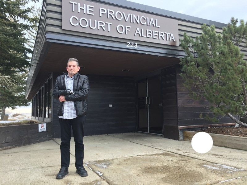 John Sears stands outside Turner Valley Provincial Court on Jan. 26. Sears flew to Alberta from Ontario to attend a sentencing hearing for a contracting company, involved in