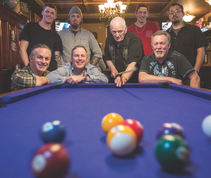 The Carey family surrounds George Carey at The George in Okotoks on Feb. 6 for the third annual George Carey 9-Ball Tournament. Top row from left: Trace, Joel, Garth, Joe and 