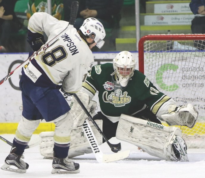 Okotoks Oilers goaltender Riley Morris blocks a shot by Spruce Grove Saints rightwing Riley Simpson at Pason Centennial Arena on Feb. 6. The Saints scored twice in the third