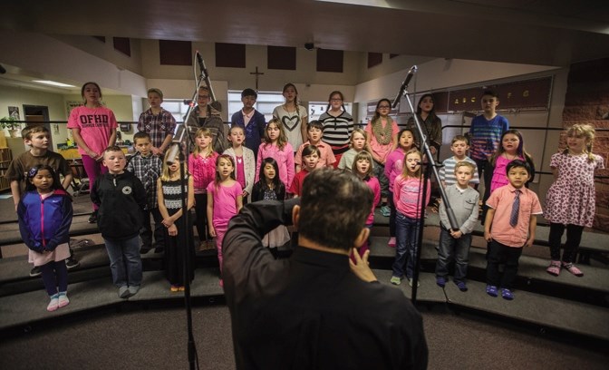 Terry Siqueira conducts Grade 3 and 6 students as they record St. Mary&#8217; s School&#8217; s newest song, titled the St. Mary&#8217; s Way, in Okotoks on Feb. 24.