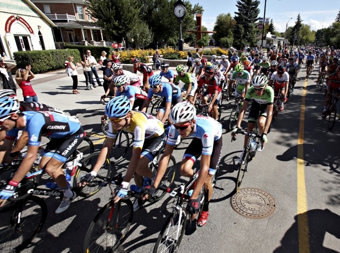 Cyclists ride through Olde Towne Okotoks to begin the fifth leg of the Tour of Alberta in 2013.