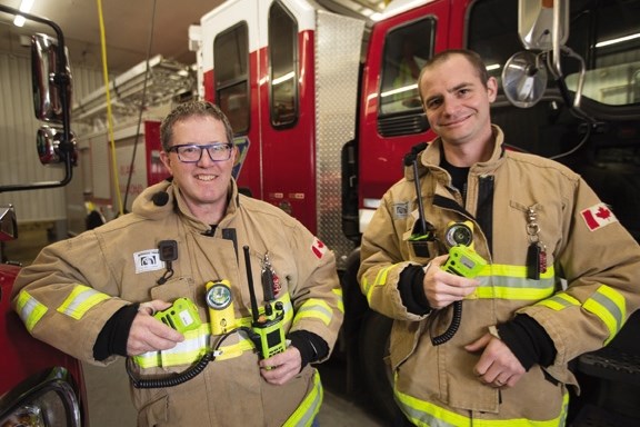 Black Diamond fire chief Jamie Campbell, left, and firefighter Dave Meikle sport the new radios the department is using, which will phase them into the Alberta First