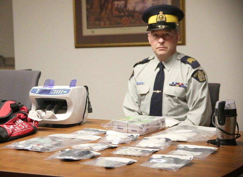 Okotoks RCMP Staff Sgt. Jim Ross site unveils $45,000 worth of cocaine, fentanyl and ecstasy, as well as drug paraphenalia seized from a Calgary storage locker linked to the