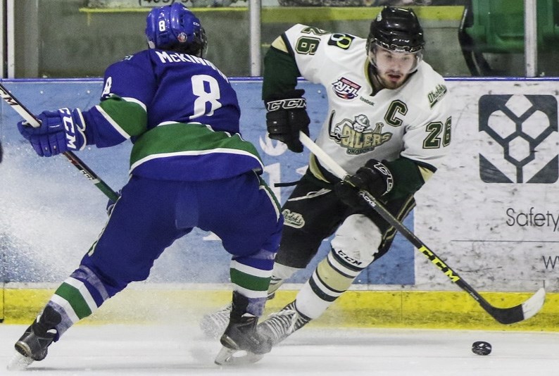 Connor Chambers controls the puck past Calgary Canuck Ryan McKinnon during Okotoks&#8217; 6-2 win.