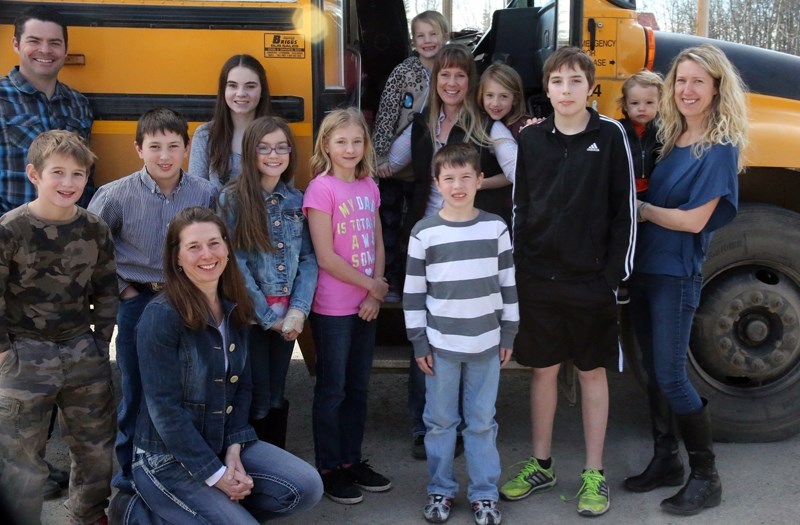Lisa Willis, on bus step, is surrounded by some of her passengers and their parents at Millarville School on March 9. Willis was named the Bus Driver of the Year by the