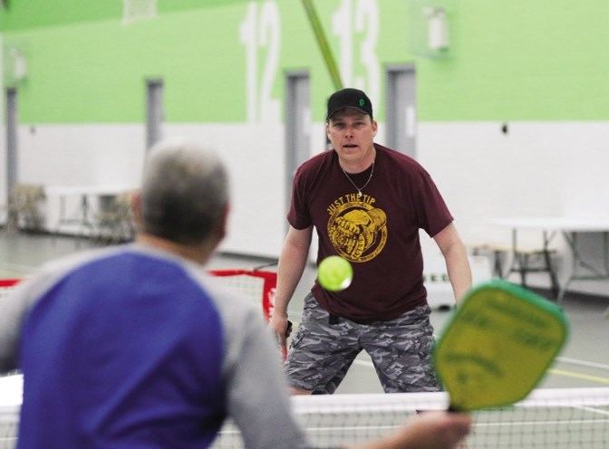 Terry Bressanutti, left, prepares to return a shot by Chris Ruddock during a game of pickleball at the Legacy Regional Field House on Mar. 10.